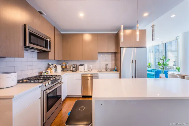 a kitchen with a refrigerator a stove and a microwave
