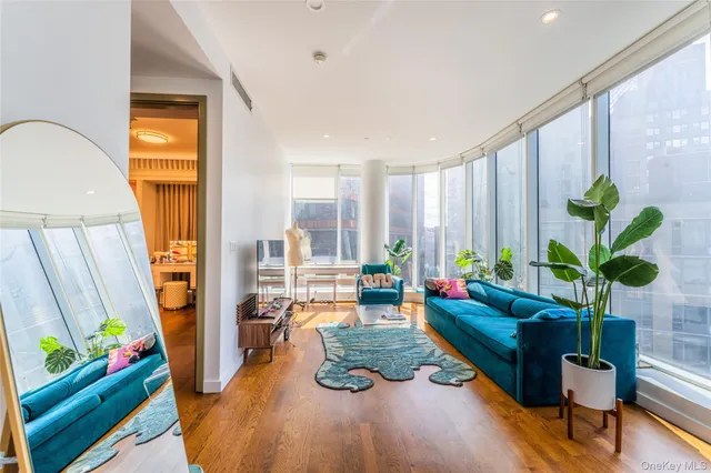 a living room with furniture fireplace and wooden floor