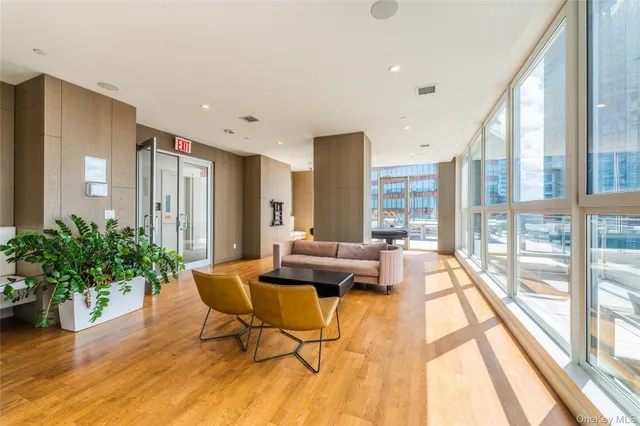 a living room with furniture and large windows