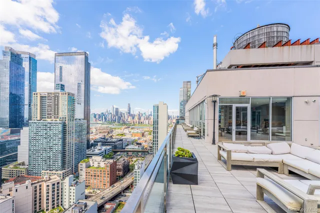 a front view of a house with outdoor seating