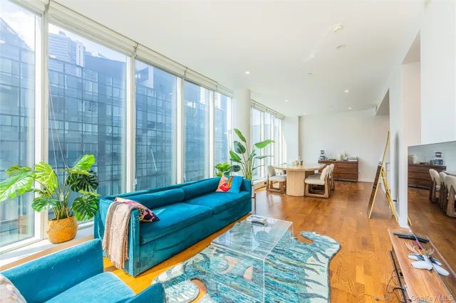 a living room with furniture and potted plant