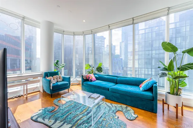 a living room with furniture and a potted plant