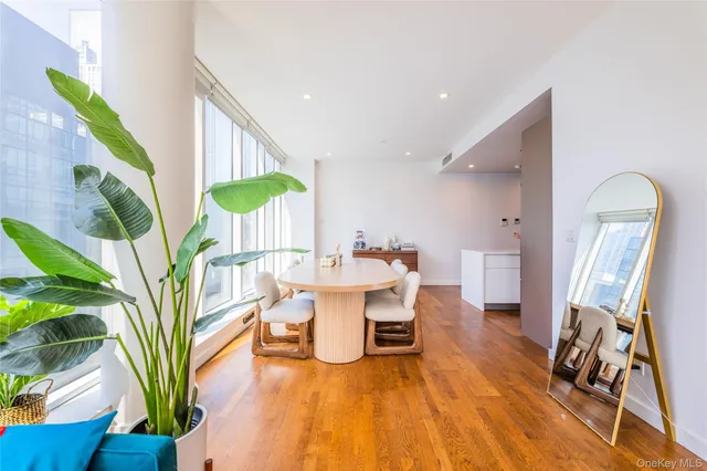 a living room with furniture a piano and a potted plant