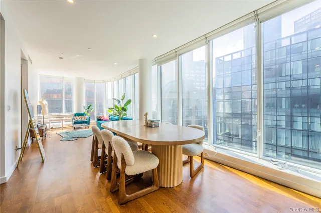 a dining room with furniture and a large window