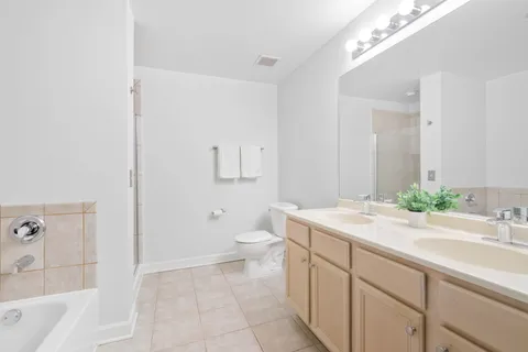 a spacious bathroom with a sink a toilet and shower