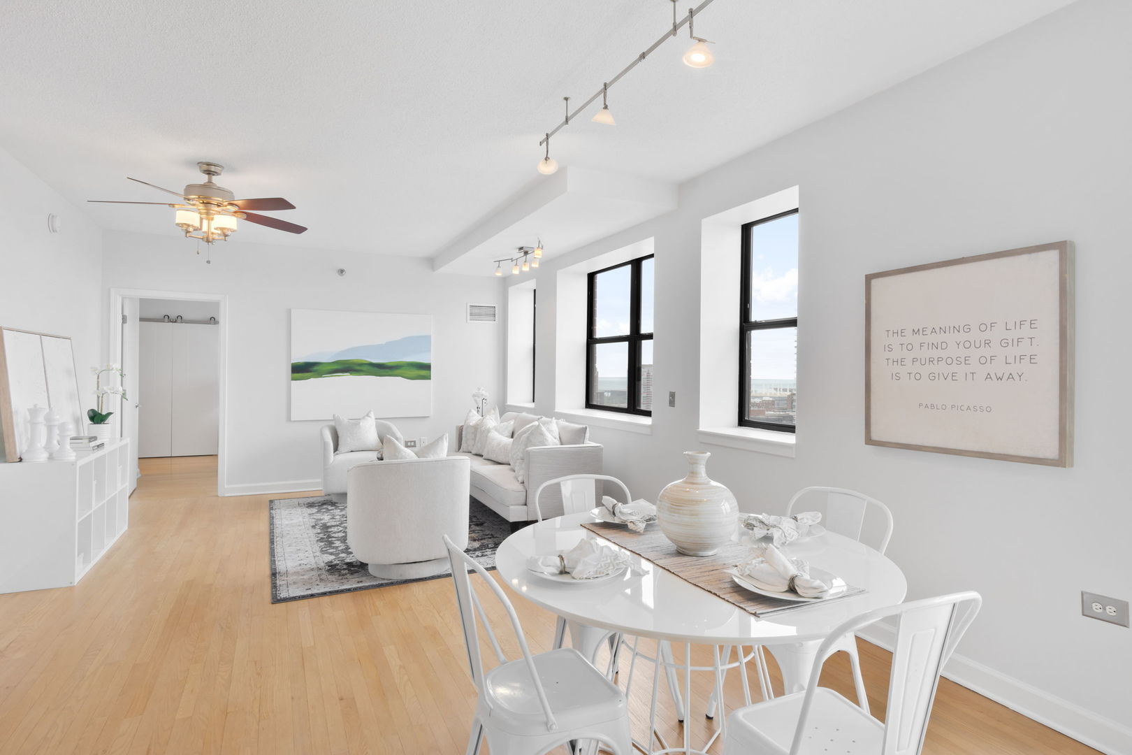 1529 South State Street, Unit 22K Chicago, IL 60605 - Photo 2 of 20 a living room with furniture a chandelier fan and a window