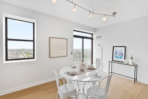 a view of a dining room with furniture and a window