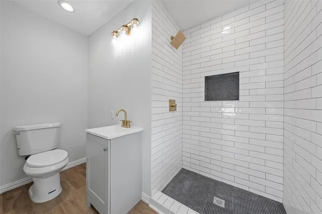 a bathroom with a toilet a sink and mirror