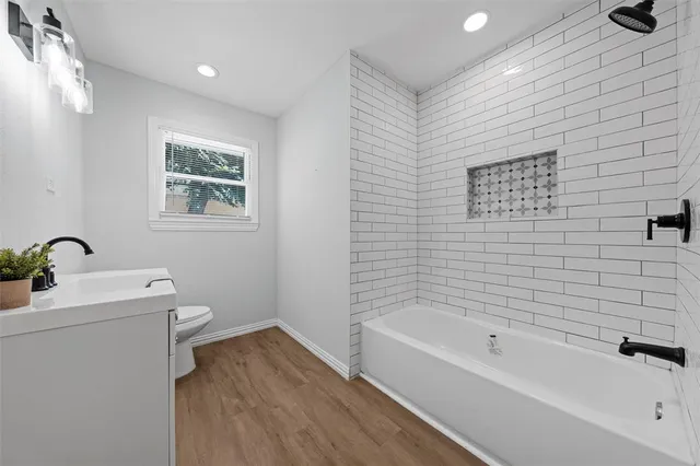 a bathroom with a toilet sink and bathtub