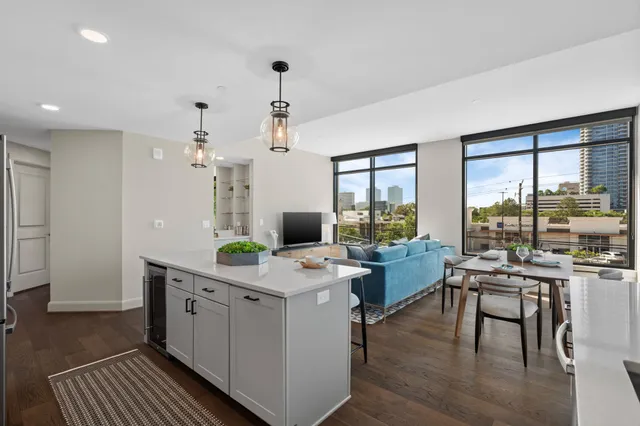 a room with furniture a large window and wooden floors
