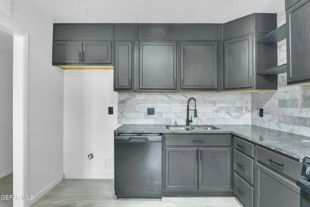 a kitchen with stainless steel appliances granite countertop a sink stove and cabinets