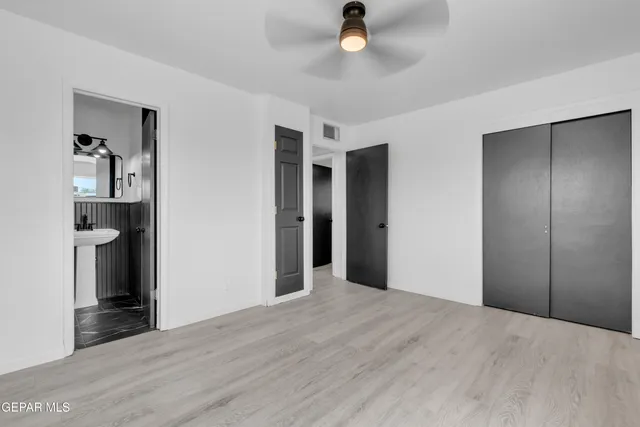 a view of a kitchen with a sink and a refrigerator