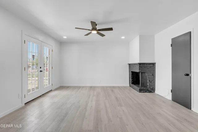 wooden floor in an empty room with a fireplace
