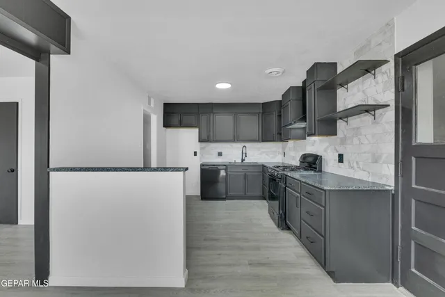 a kitchen with stainless steel appliances a refrigerator stove and sink