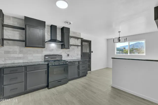 a kitchen with stainless steel appliances granite countertop a stove and a refrigerator