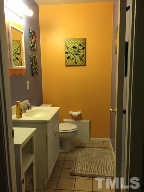 5141 Revere Road, Unit 23 Durham, NC 27713 - Photo 11 of 20 a bathroom with a sink a toilet and mirror