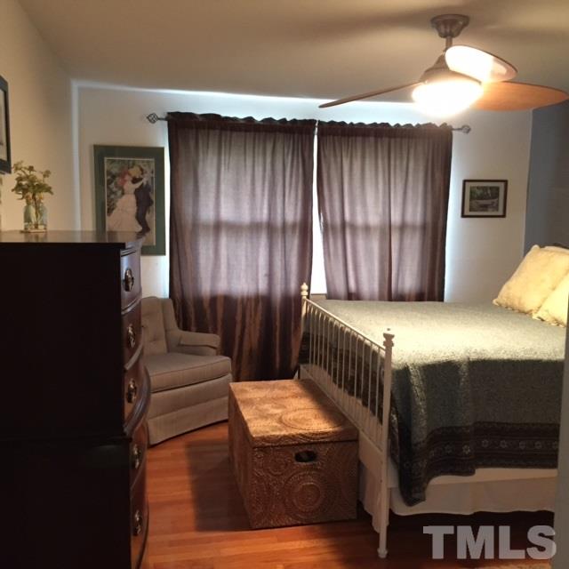 5141 Revere Road, Unit 23 Durham, NC 27713 - Photo 13 of 20 a bedroom with a bed and a dresser