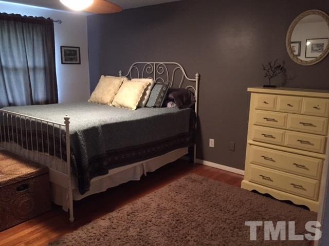 5141 Revere Road, Unit 23 Durham, NC 27713 - Photo 14 of 20 a bedroom with a bed and a mirror