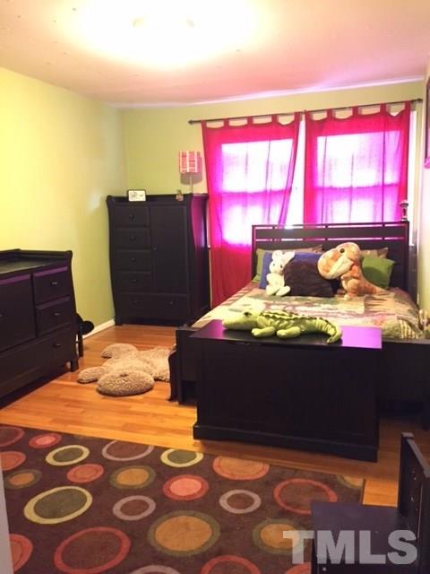 5141 Revere Road, Unit 23 Durham, NC 27713 - Photo 16 of 20 a bed sitting in a bedroom next to a window