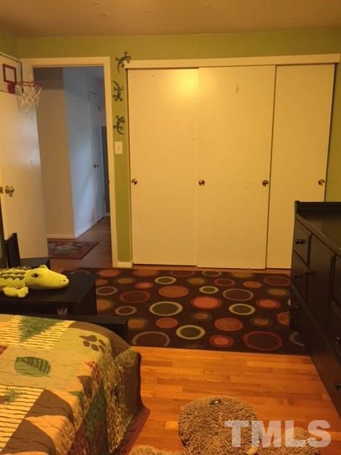 5141 Revere Road, Unit 23 Durham, NC 27713 - Photo 17 of 20 a bedroom with a bed and a flat screen tv