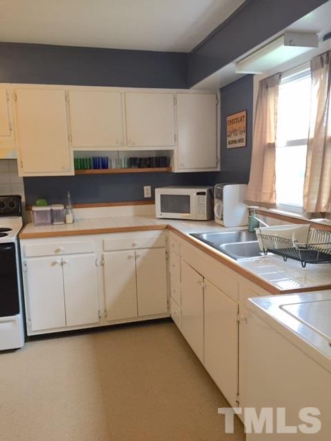 5141 Revere Road, Unit 23 Durham, NC 27713 - Photo 3 of 20 a kitchen with sink cabinets and window