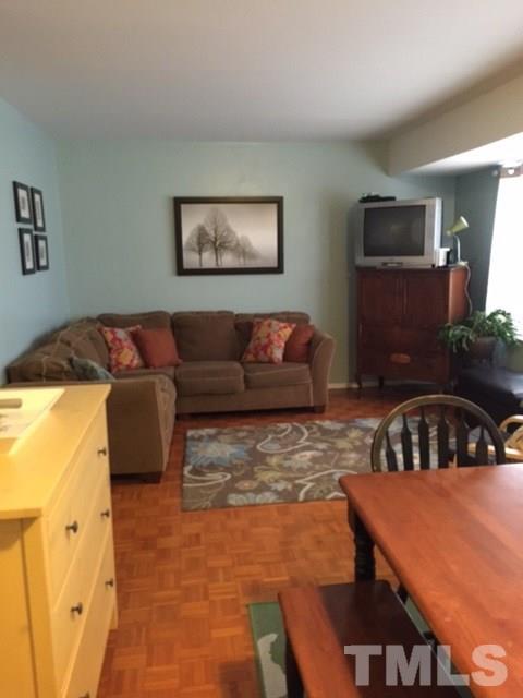 5141 Revere Road, Unit 23 Durham, NC 27713 - Photo 7 of 20 a living room with furniture and a flat screen tv