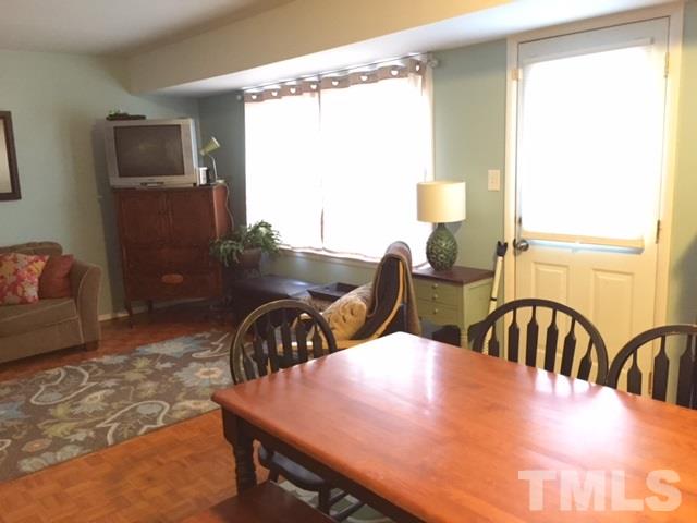 5141 Revere Road, Unit 23 Durham, NC 27713 - Photo 8 of 20 a view of a dining room with furniture and a window