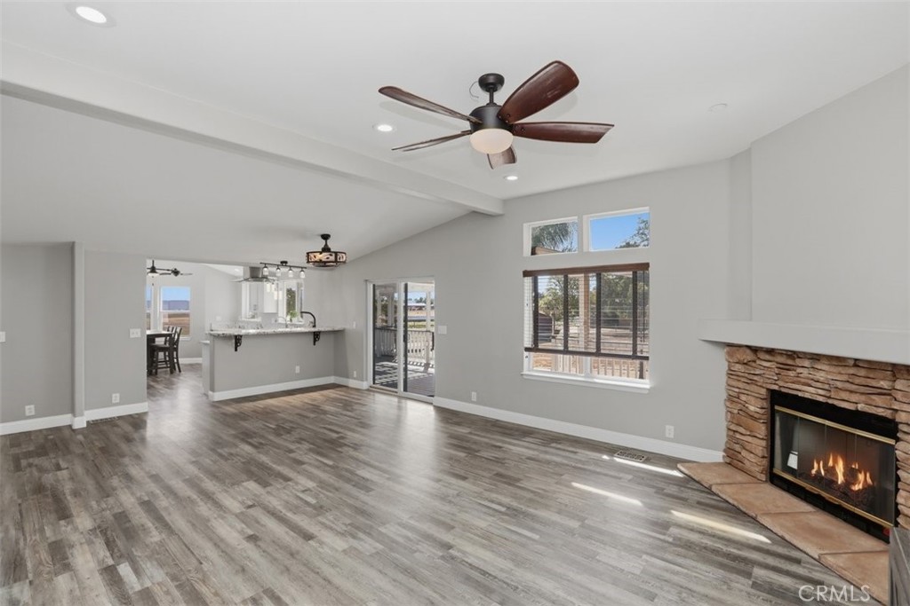 33634 Howard Way Menifee, CA 92584 - Photo 11 of 53 a living room with stainless steel appliances kitchen island a fireplace and wooden floor