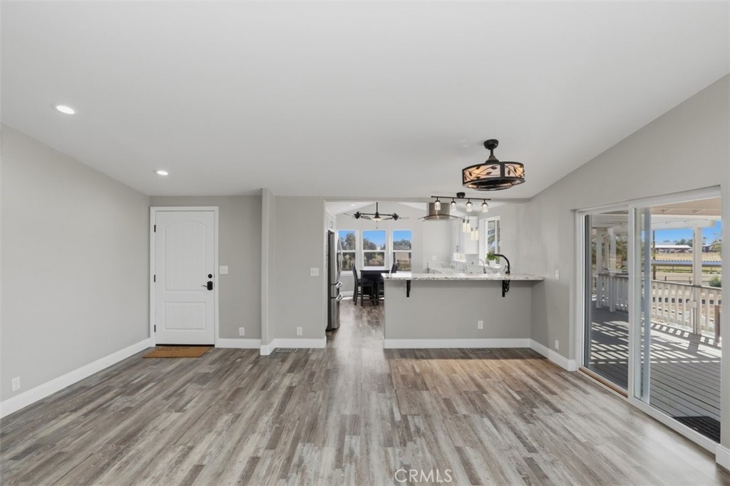 33634 Howard Way Menifee, CA 92584 - Photo 12 of 53 a view of a living room and kitchen space with wooden floor