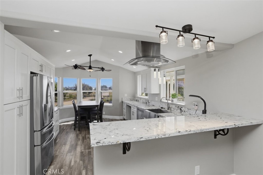 33634 Howard Way Menifee, CA 92584 - Photo 14 of 53 a kitchen with stainless steel appliances granite countertop a sink refrigerator and cabinets