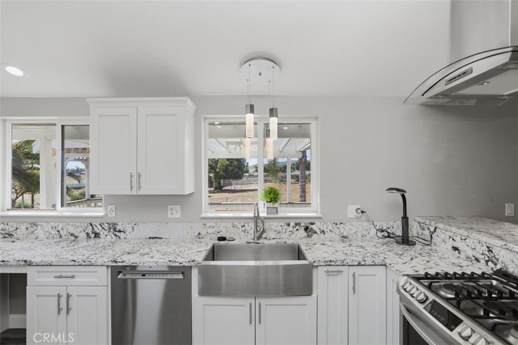 33634 Howard Way Menifee, CA 92584 - Photo 16 of 53 a kitchen with stainless steel appliances granite countertop a sink stove and cabinets