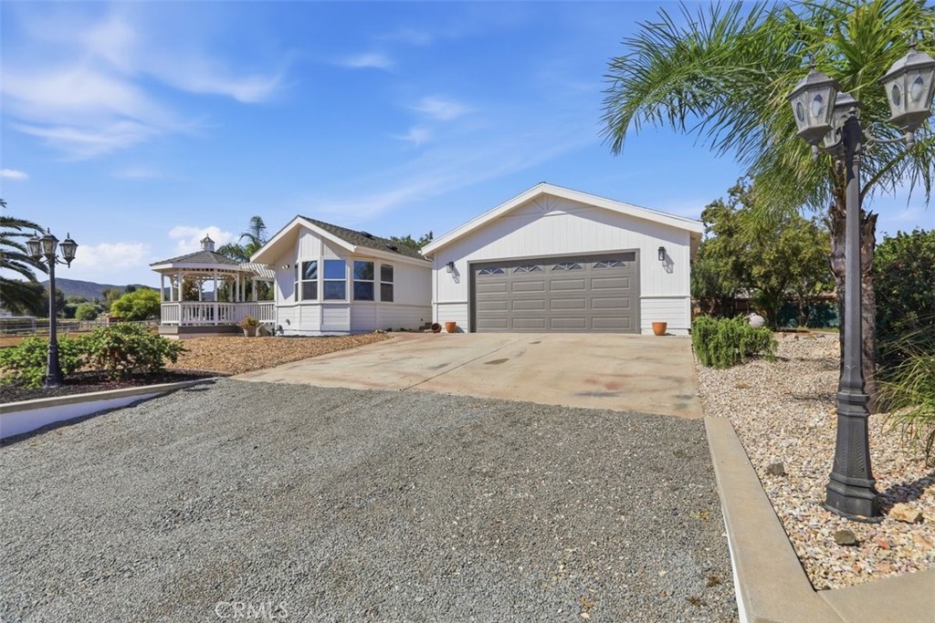 33634 Howard Way Menifee, CA 92584 - Photo 52 of 53 a front view of a house with a yard and garage