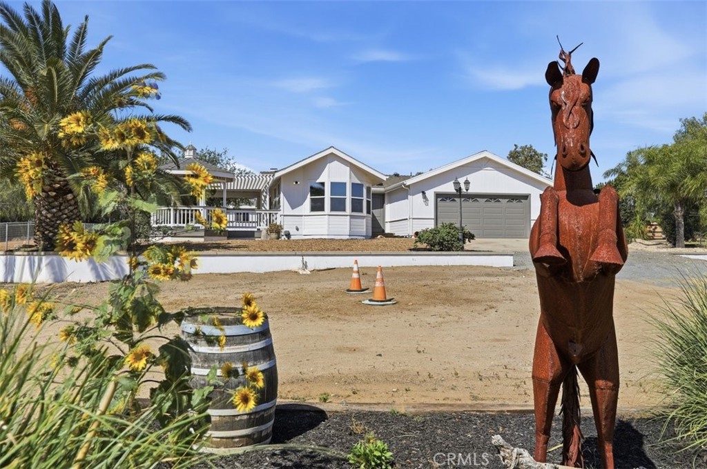 33634 Howard Way Menifee, CA 92584 - Photo 7 of 53 a front view of a house with a yard