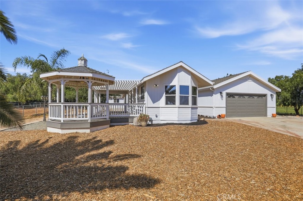 33634 Howard Way Menifee, CA 92584 - Photo 8 of 53 a front view of a house with a yard