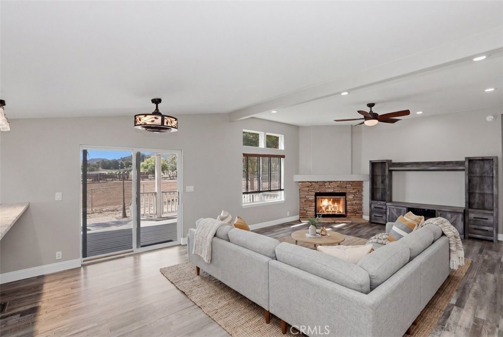 33634 Howard Way Menifee, CA 92584 - Photo 9 of 53 a living room with furniture a fireplace and a flat screen tv