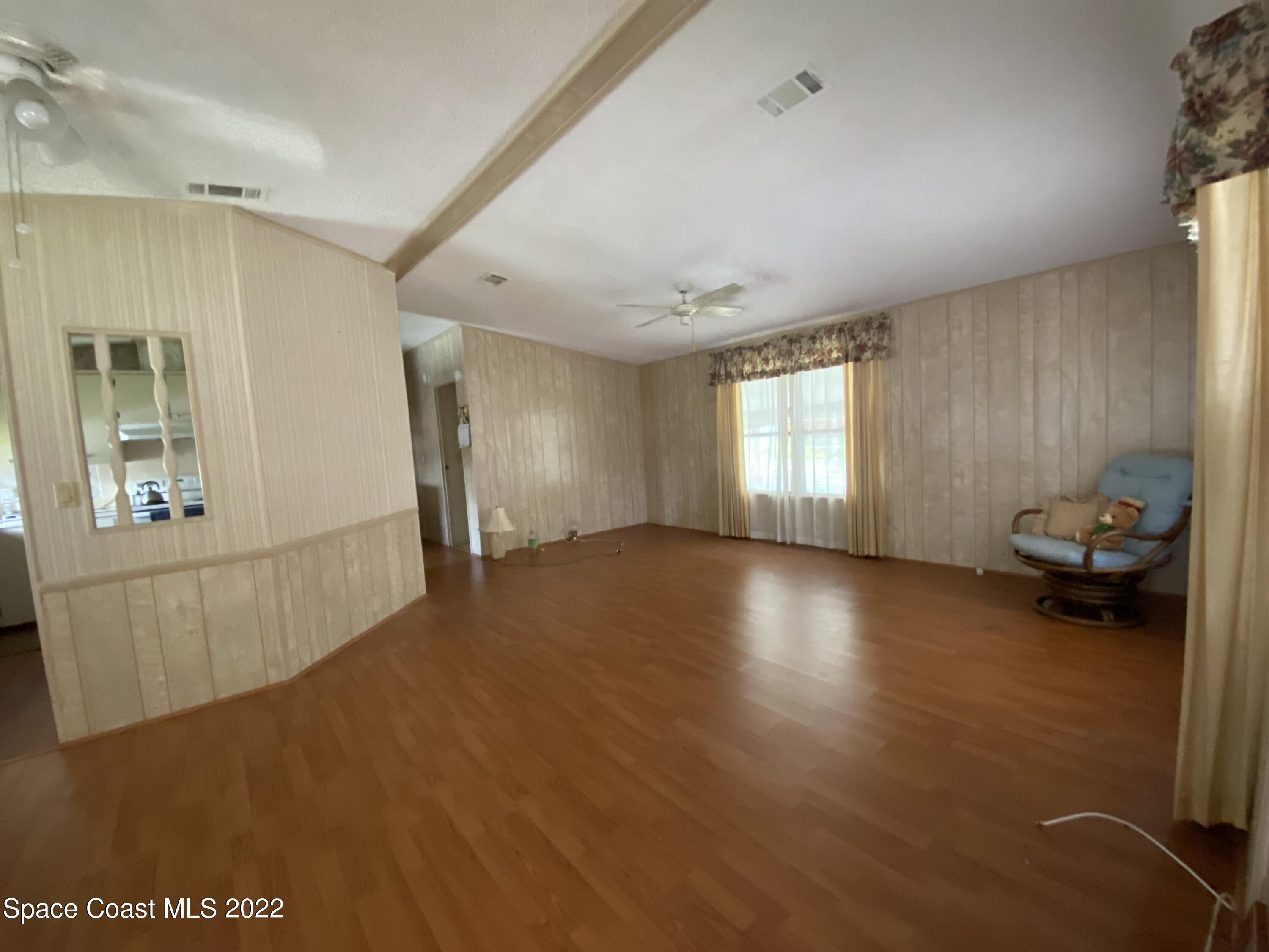 1352 Barefoot Circle Barefoot Bay, FL 32976 - Photo 11 of 40 a view of livingroom with hardwood floor and a window