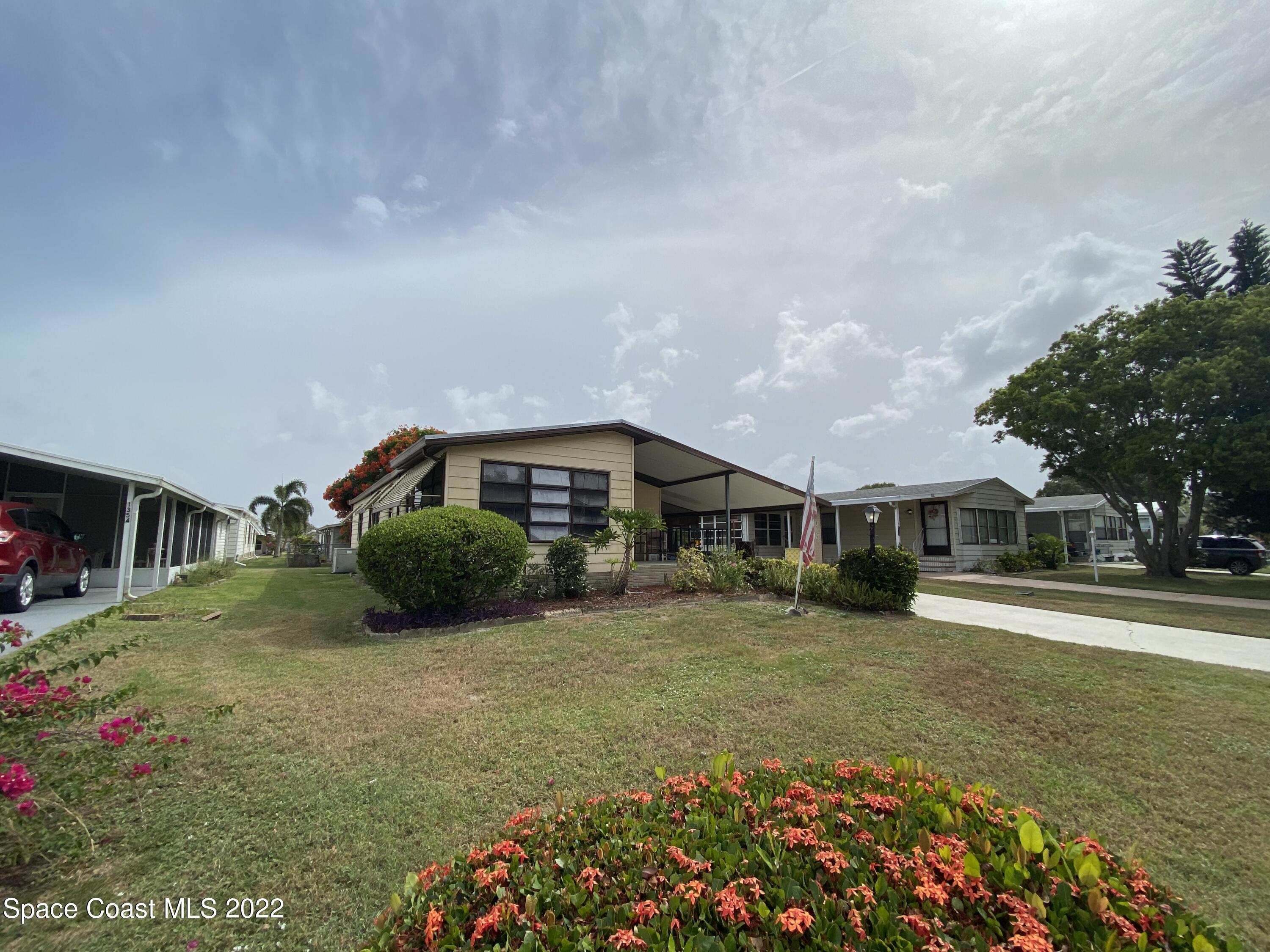 1352 Barefoot Circle Barefoot Bay, FL 32976 - Photo 3 of 40 a front view of a house with a yard