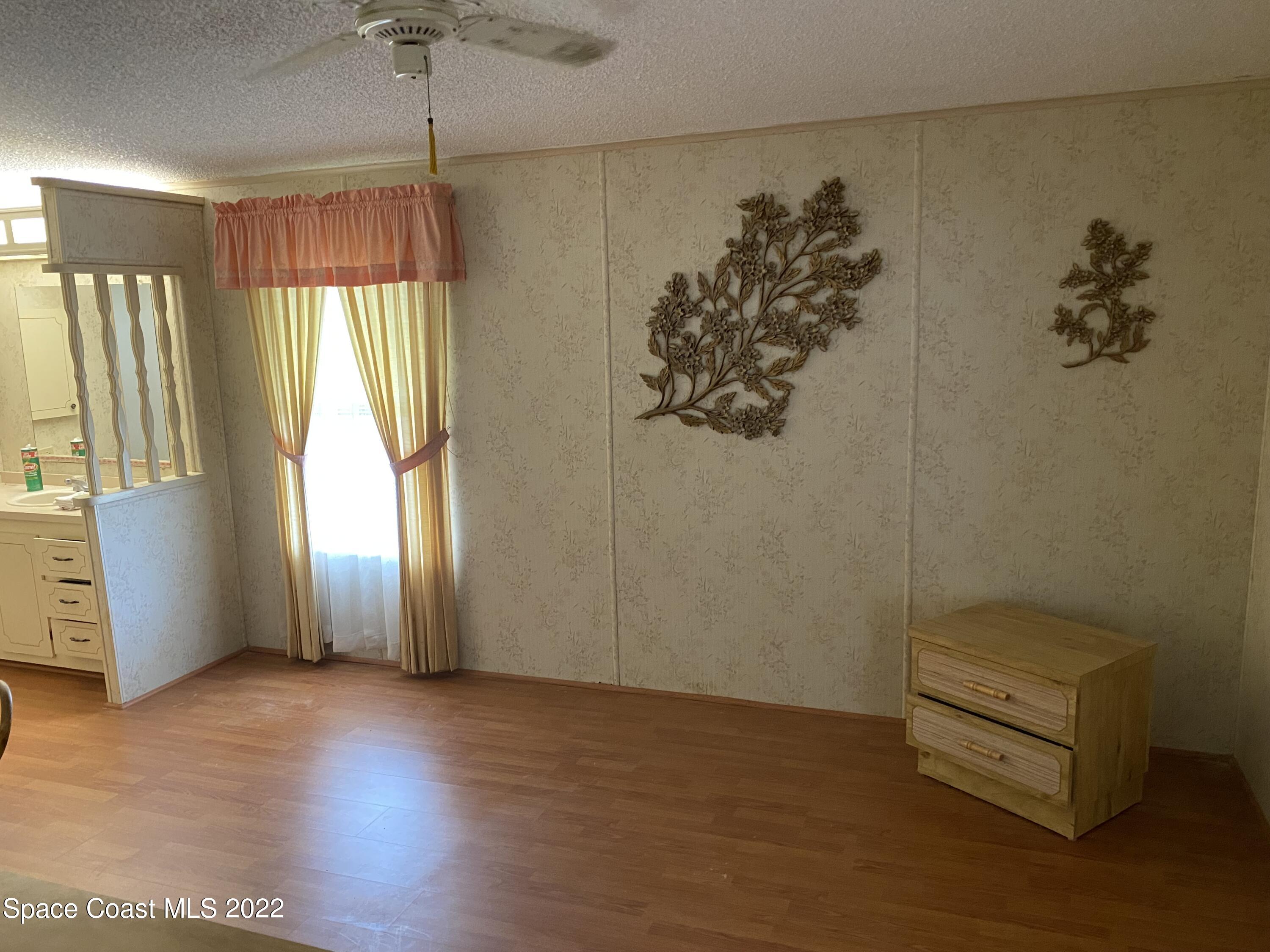 1352 Barefoot Circle Barefoot Bay, FL 32976 - Photo 35 of 40 wooden floor in an empty room with a window