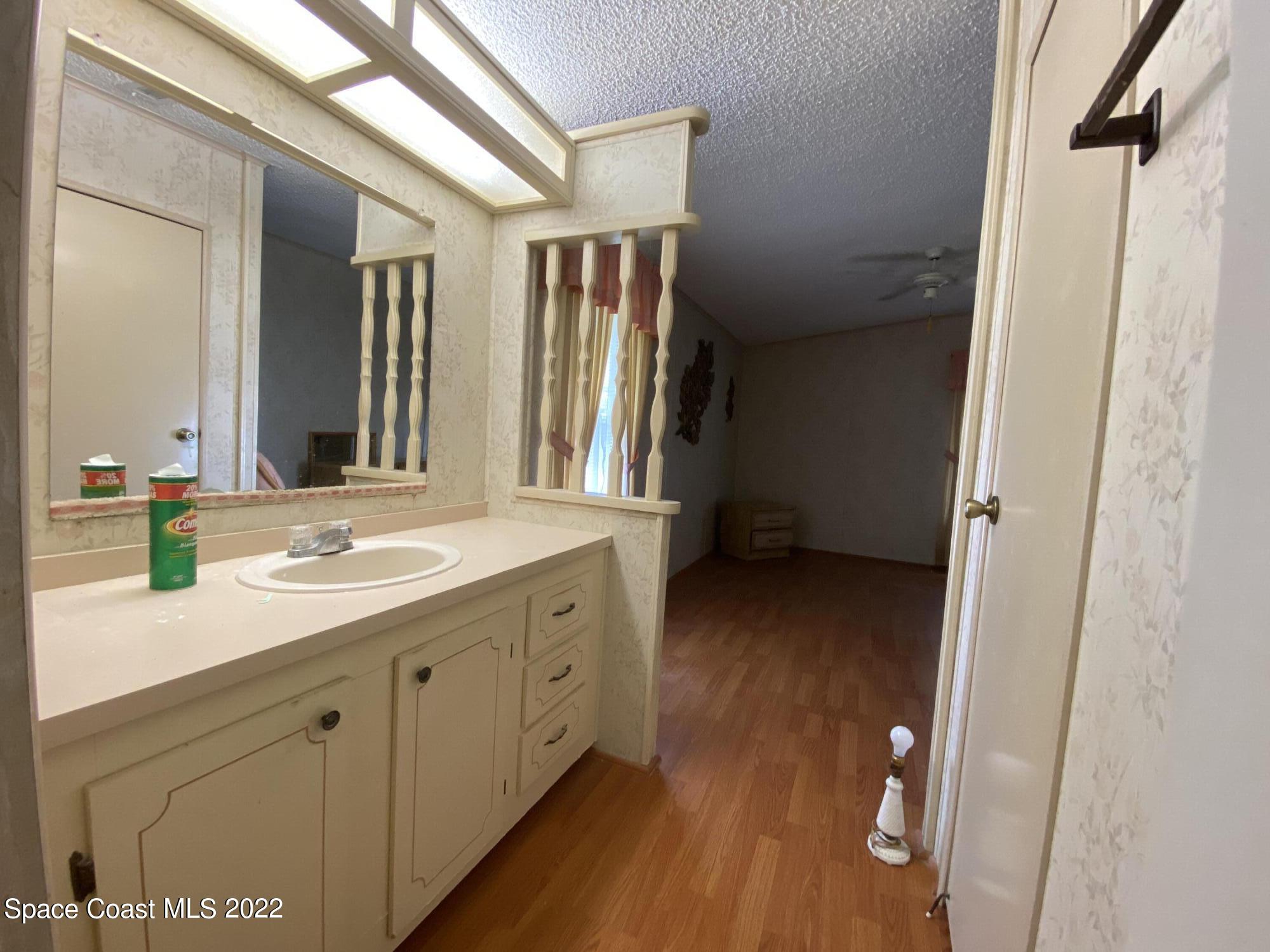 1352 Barefoot Circle Barefoot Bay, FL 32976 - Photo 39 of 40 a bathroom with a double vanity sink and a mirror