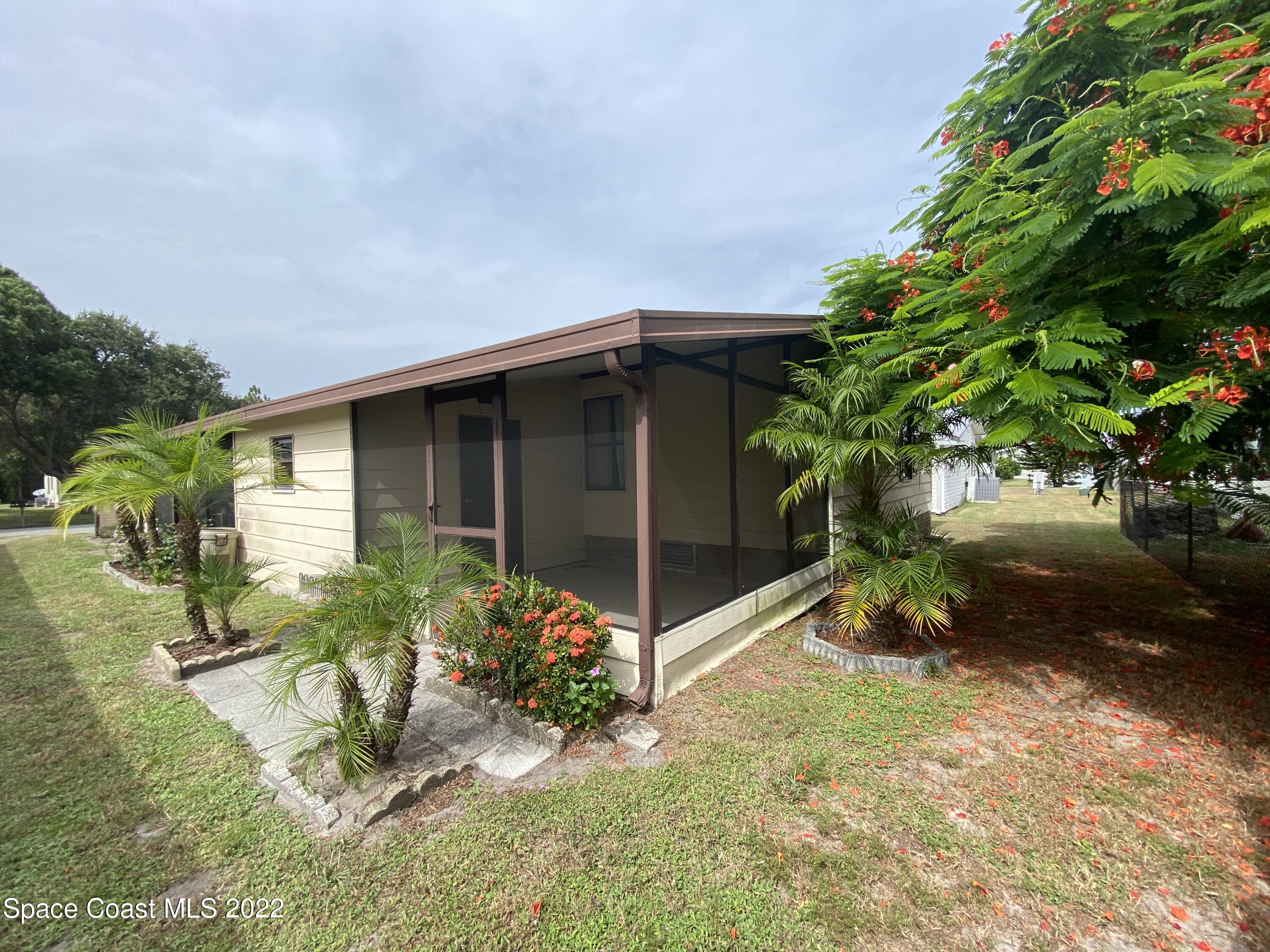 1352 Barefoot Circle Barefoot Bay, FL 32976 - Photo 8 of 40 a front view of a house having yard