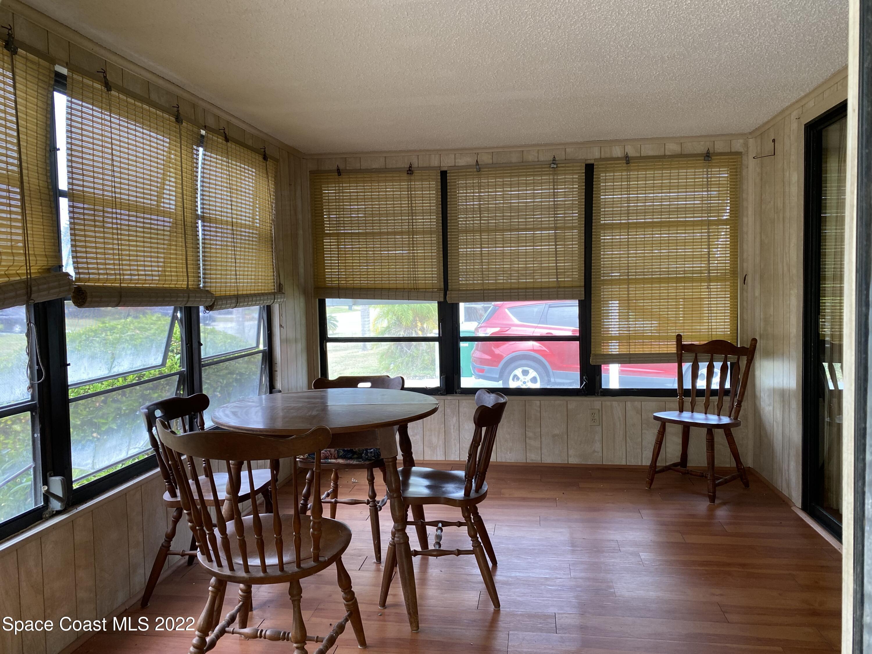 1352 Barefoot Circle Barefoot Bay, FL 32976 - Photo 9 of 40 a dining room with furniture and window