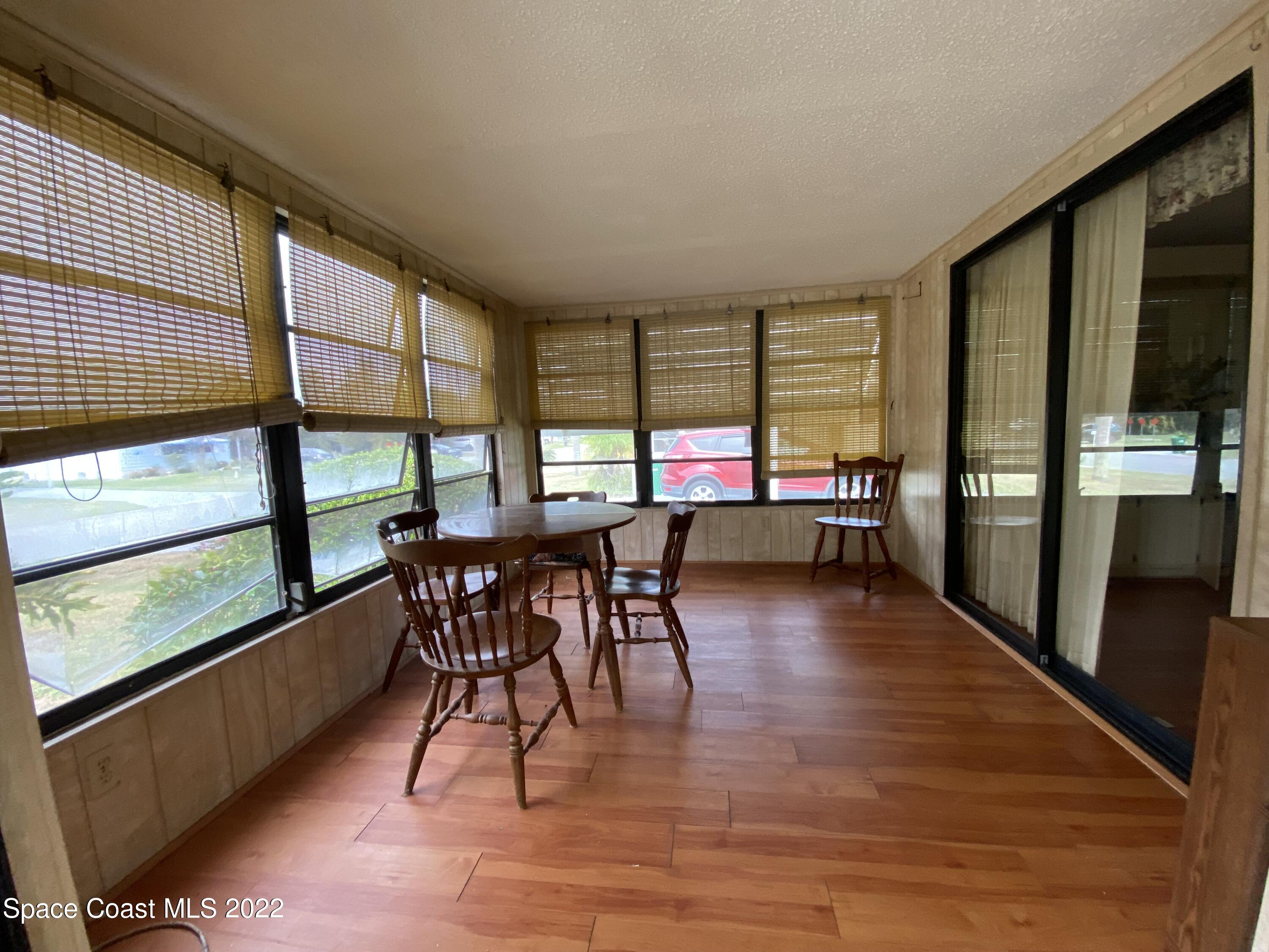 1352 Barefoot Circle Barefoot Bay, FL 32976 - Photo 10 of 40 wooden floor in a hall with a large window and wooden floor