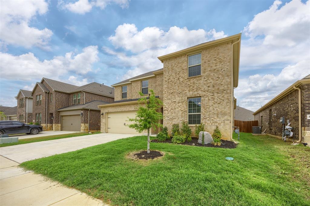 3808 High Country Road Aubrey, TX 76227 - Photo 4 of 36 Two-story residence featuring light-colored brick facade and a two-car garage