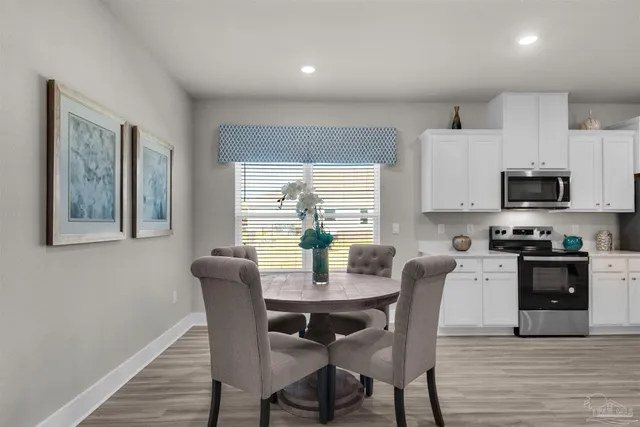 a view of a dining room with furniture window and wooden floor