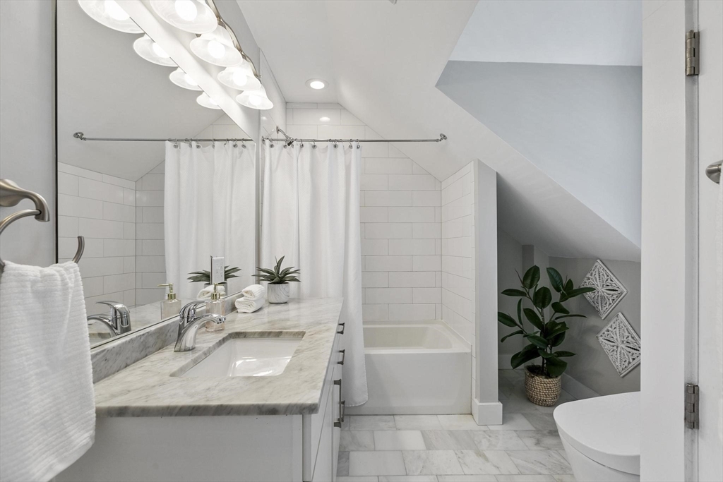 591 Somerville Avenue, Unit 7 Somerville, MA 02143 - Photo 11 of 20 a bathroom with a granite countertop sink a toilet and bathtub
