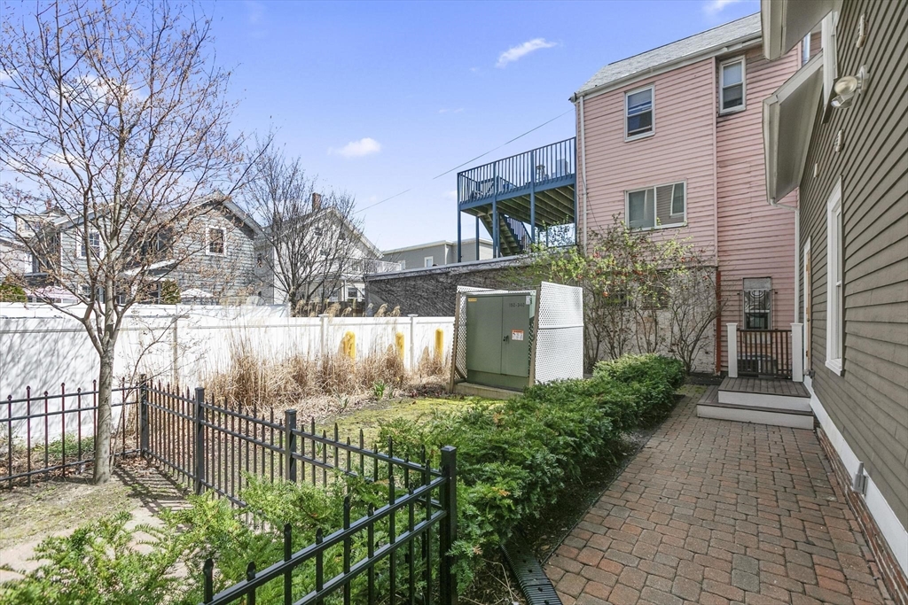 591 Somerville Avenue, Unit 7 Somerville, MA 02143 - Photo 17 of 20 a front view of a house with garden