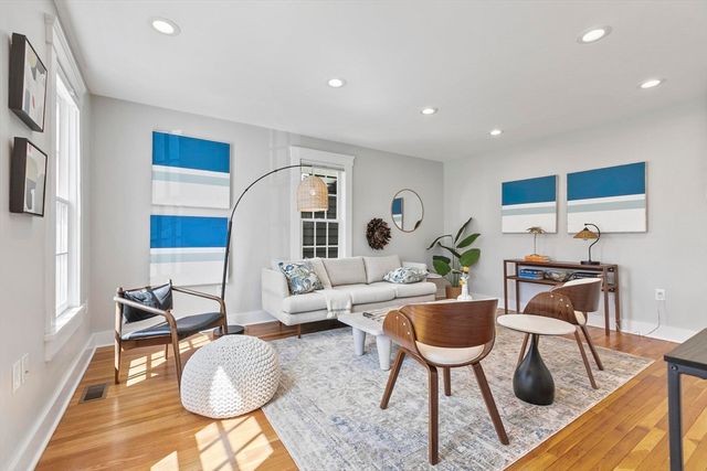 a living room with furniture a rug and a table