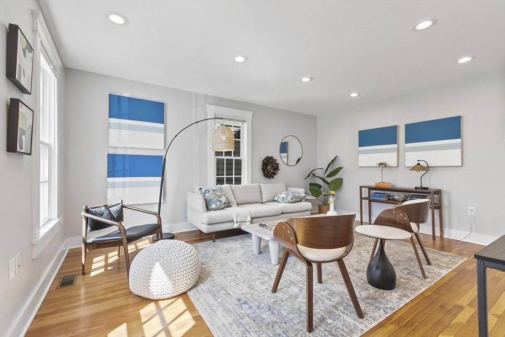 591 Somerville Avenue, Unit 7 Somerville, MA 02143 - Photo 4 of 20 a living room with furniture a rug and a table