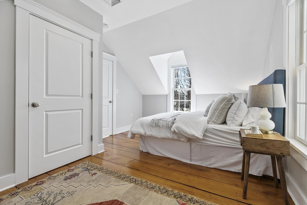 591 Somerville Avenue, Unit 7 Somerville, MA 02143 - Photo 8 of 20 a bedroom with a bed and a window