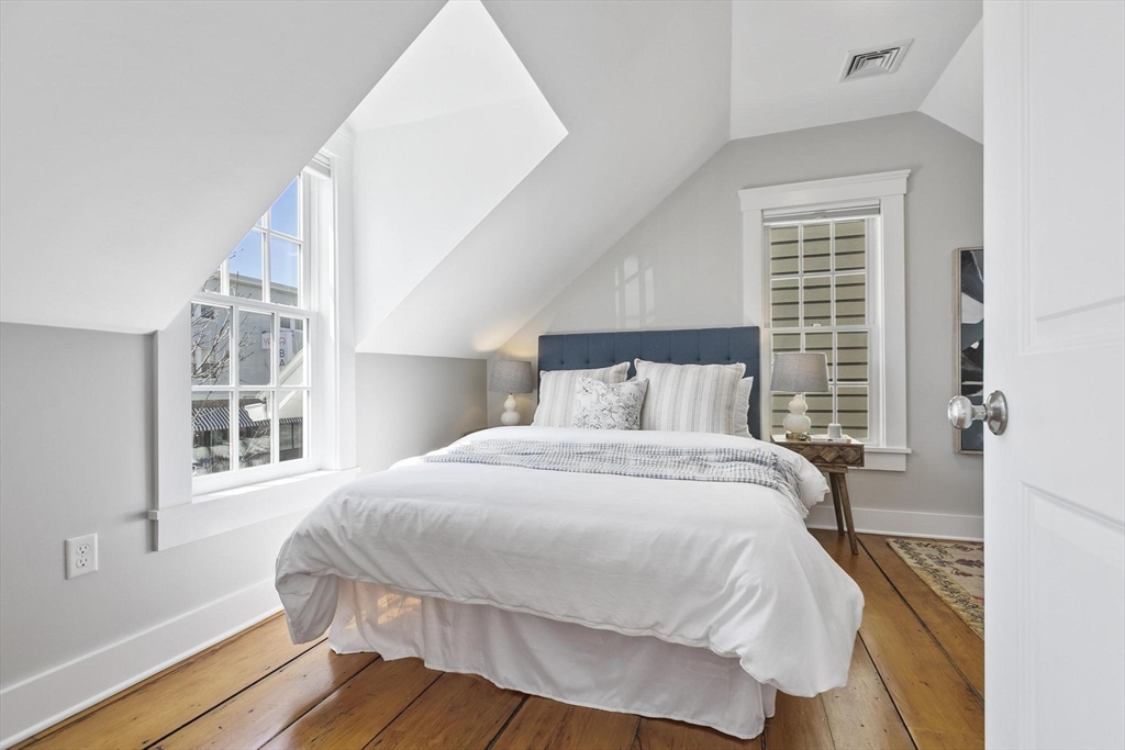 591 Somerville Avenue, Unit 7 Somerville, MA 02143 - Photo 9 of 20 a bedroom with a bed and wooden floor